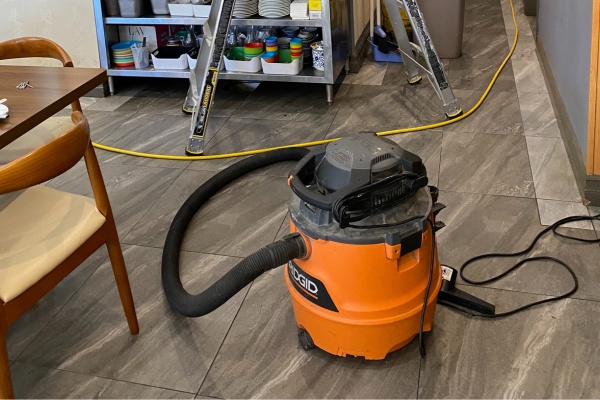 Clogged dryer vent repair process in a New Jersey residential setting demonstrating the use of vacuums and tools