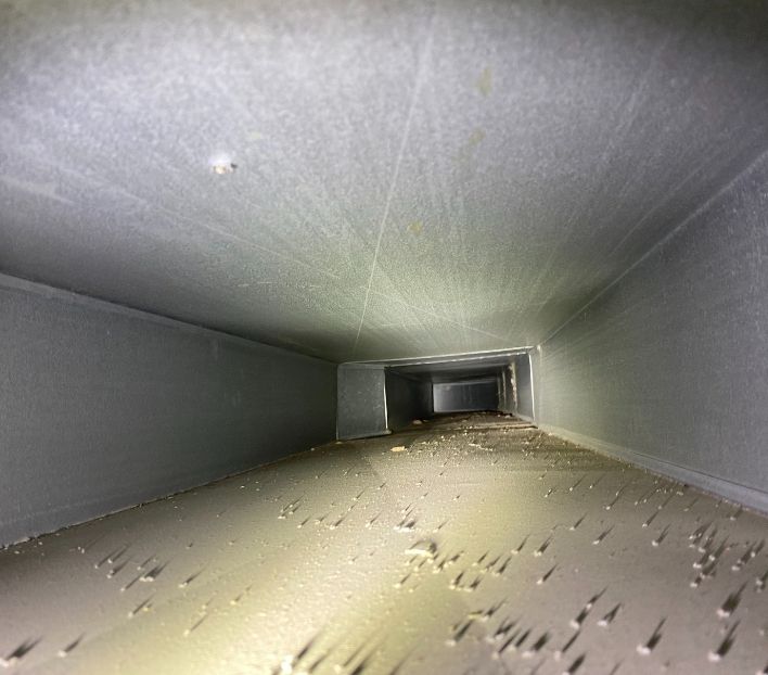 Coated air duct system inspection revealing accumulated dust in NJ residential property