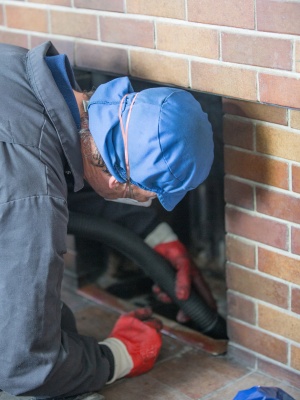 Chimney cleaning service in New Jersey performing maintenance on a residential fireplace Chimney cleaning service in New Jersey performing maintenance on a residential fireplace