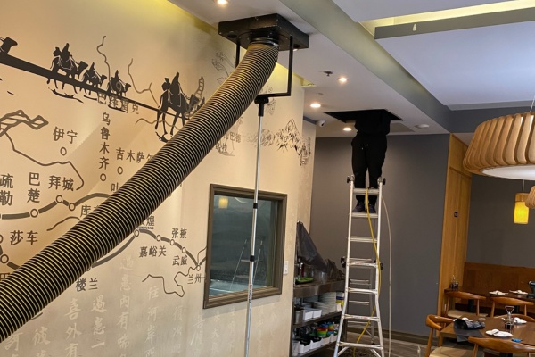 HVAC UV light installation in a restaurant in New Jersey with technician on a ladder and ventilation equipment HVAC UV light installation in a restaurant in New Jersey with technician on a ladder and ventilation equipment